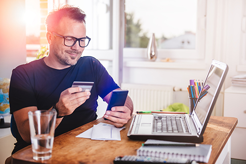 man with credit card and passport on computer