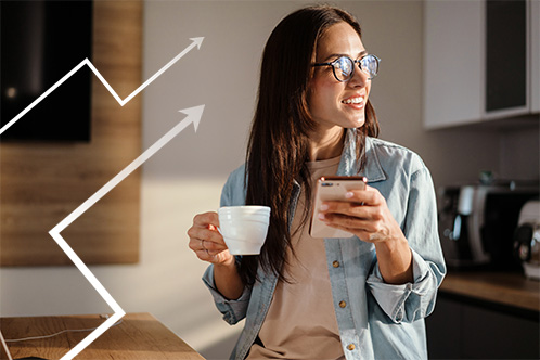 22_IndexedMoneyMarket_438x332 Image of woman holding a phone and a cup of coffee