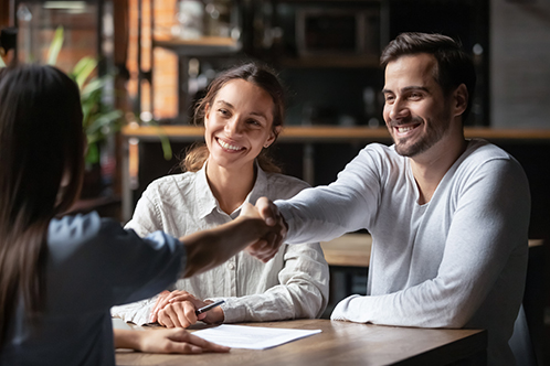 Financialcoaches 498x332 couple shaking hands with a coach